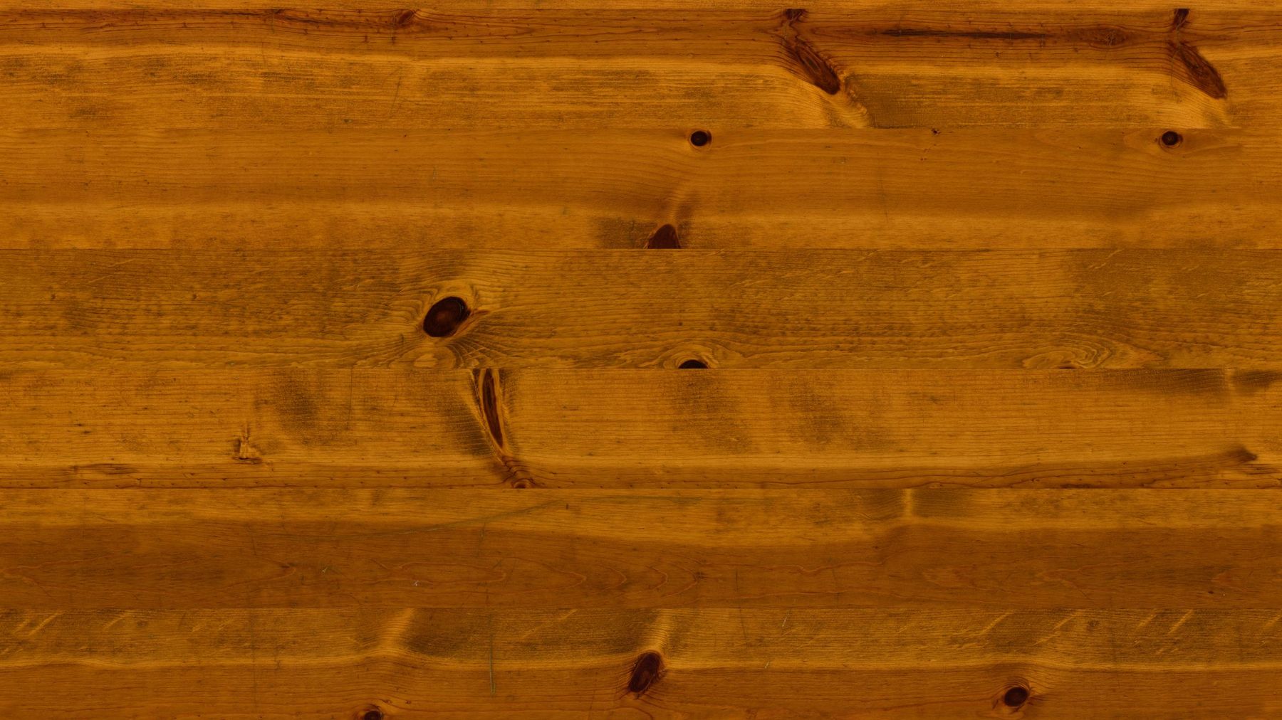 Close-up of sanded pine tabletop grain, hand-stained